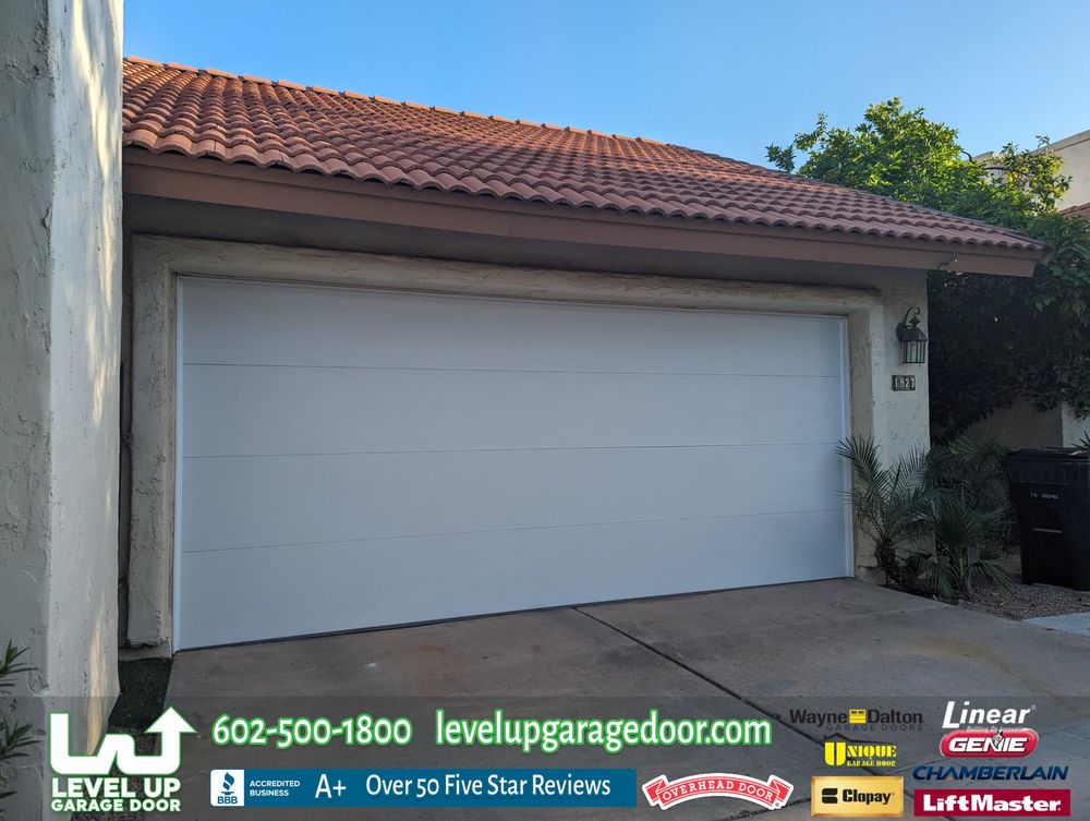 New white sectional garage doors on an Arizona stucco home with curb appeal
