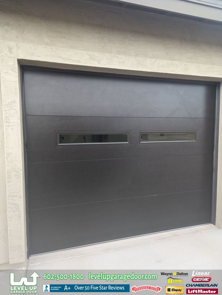 Modern flush-panel garage door installed by Level Up Garage Door